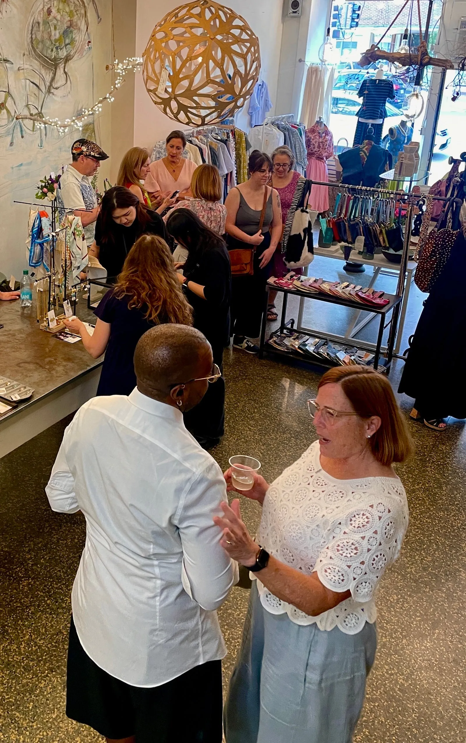 Customers and makers gathered together in the shop during an evening event
