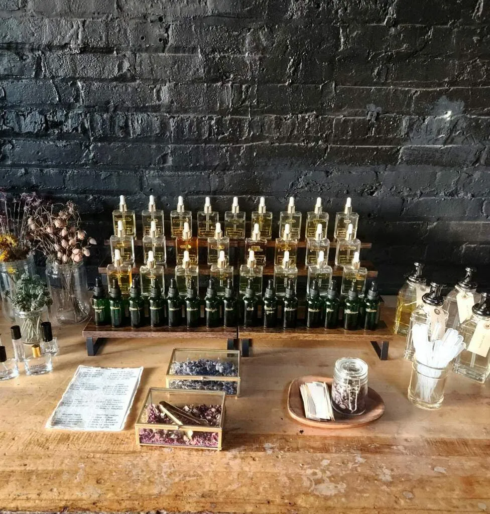 Apothecary bottles and dried flowers arranged on a reclaimed wood table